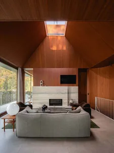 A modern living room featuring wood materials and contemporary furniture.