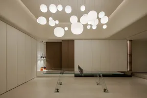 A modern, minimalist living room with a glass table.