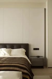 Modern bedroom with minimalist design, neutral tones, and clean lines.