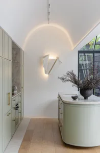 Modern residential kitchen with marble countertops and minimalist design.