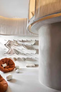 Concrete playroom with climbing wall and soft seating