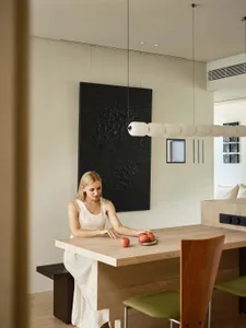 A minimalist dining space featuring wooden furniture with apples on the table