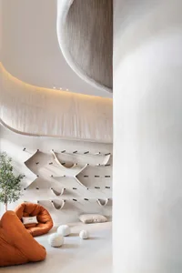 Modern minimalist living space with fabric elements and beige color palette.