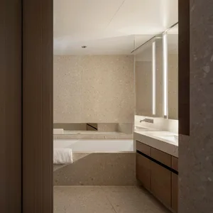 Modern bathroom featuring a terrazzo countertop and ceiling-mounted mirror.