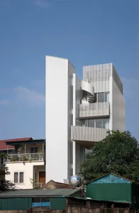 A modern building exterior with a spiral staircase and metal materials.