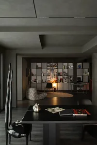 A modern home office with concrete elements and a large dark table.