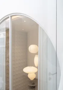 A modern interior design space with white paper lamp shades.
