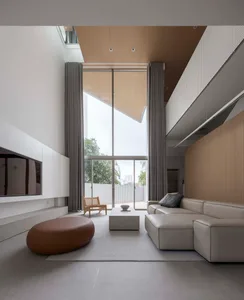 A modern living room with concrete flooring and minimalist design features.