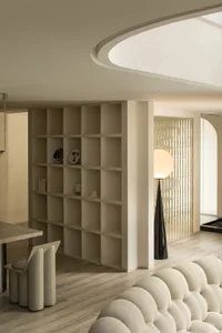Modern living room with neutral-toned furniture and wooden flooring.