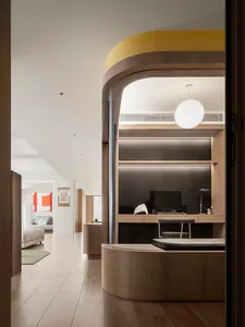 A modern residential interior featuring a curved wooden wall and sleek furniture.