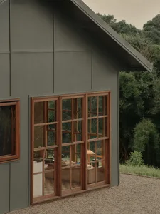 Modern building exterior with green-gray walls and wooden framings
