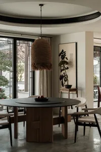 Circular dining table with wooden legs and a stone tabletop.