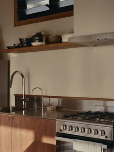 Modern kitchen with metallic accents and stainless steel appliances.