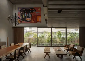 A modern living room with wooden furniture and large windows.