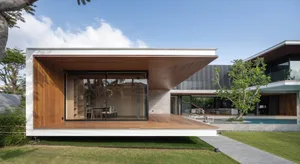 Contemporary residential home featuring a combination of wood, glass, and concrete materials.