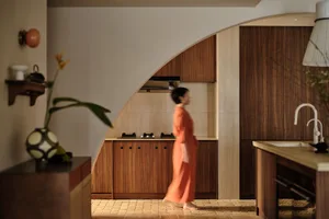 A modern residential interior with wood, stone, and glass features.