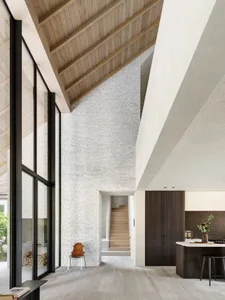 Modern residential kitchen featuring brick, wood, and concrete materials