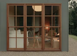A cozy, modern residential space with wooden walls, a mix of white and dark wooden furniture, and a warm, inviting atmosphere
