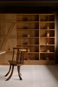 A minimalist living space featuring industrial design elements and wooden furniture.