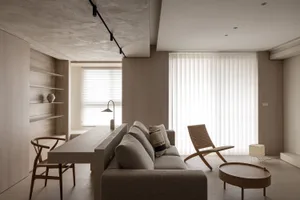A minimalist living room with neutral tones.