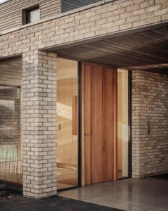 An image of a modern residential entrance with brick and glass features.