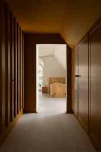 A modern interior space featuring wooden cabinets and white flooring.