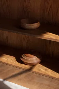 Wooden minimalist cabinets with light and shadow detail.