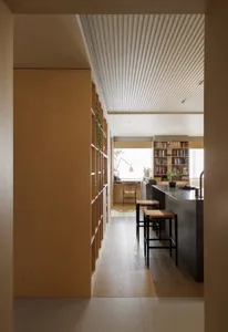 Minimalist modern kitchen featuring wooden cabinets and glass countertops, designed for efficiency and aesthetic appeal.