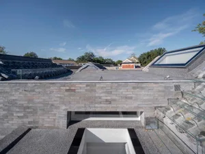 Modern building with a concrete rooftop and skylights.