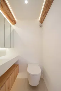 A modern bathroom featuring white wooden finishes and minimalist design.