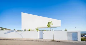 Modern white concrete house with minimalist design and open floor plan