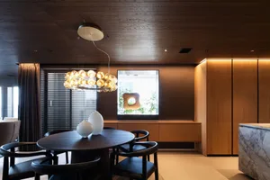 Modern dining room featuring wooden elements and minimalist design.