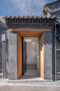 A modern entrance with stone and wooden elements.