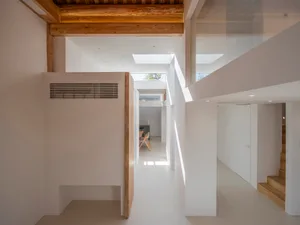 Modern interior space with white walls and flooring.