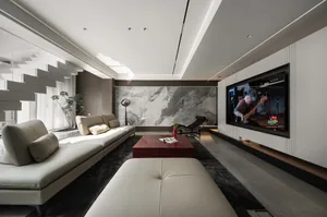 A modern living room featuring a concrete wall and a red coffee table.