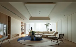 A modern living room featuring a marble coffee table, wooden seating, and fabric upholstery.