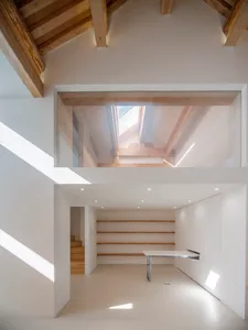 A minimalist interior with white walls and wooden accents.