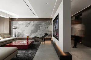 A sleek, modern minimalist living room with a combination of concrete, marble, and contrasting black and white elements.