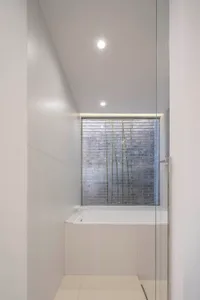 Modern bathroom with glass tiles and white soap sink
