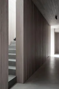 A modern interior space featuring concrete walls