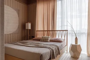 A modern minimalist bedroom with a wooden bed, beige curtains, and a large window.