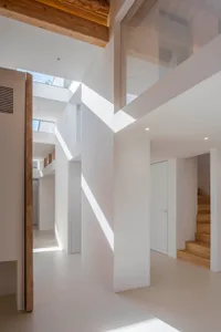 Modern white interior with wooden beams and white plaster walls