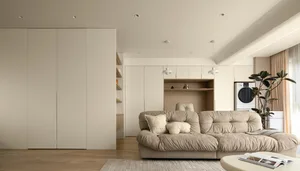 Neutral-tones minimalist living room with built-in storage and comfortable seating.