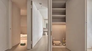 Minimalist residential interior showcasing sleek, light-colored wood and streamlined design elements.