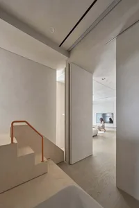 A modern, minimalist interior space with concrete stairs and minimalist design elements.