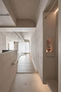 Modern minimalist interior designed with sleek concrete surfaces and minimal decor.