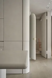 Minimalist interior with concrete walls and curved elements.