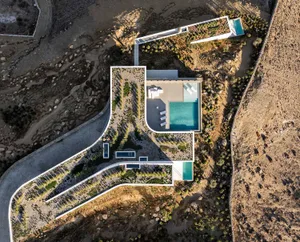 Aerial view of a modern residential architecture with concrete and glass materials.