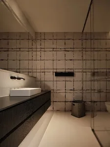 Modern industrial-style bathroom featuring concrete walls and flooring.