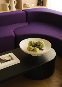 A modern interior design featuring a minimalist approach with concrete elements.